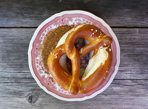 Weisswurst with homemade Pretzel Weisswurst with homemade Pretzel on timber table twisted bacon stock pictures, royalty-free photos & images