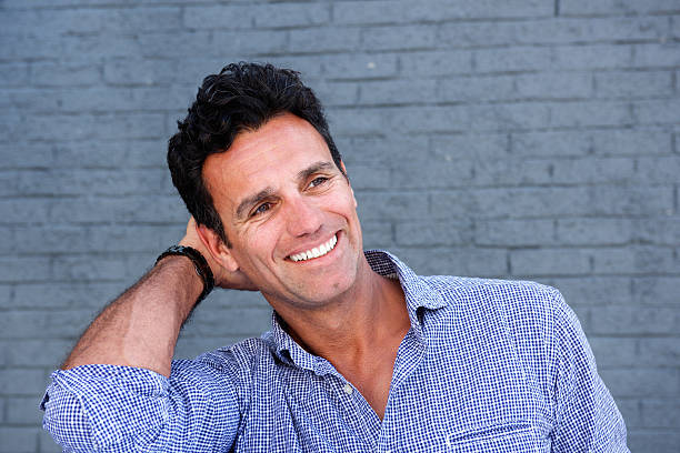 istock Close up handsome man smiling with hand in hair 533561954