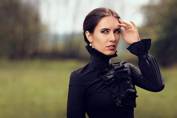 Portrait of a gothic queen outside wearing diamond earrings