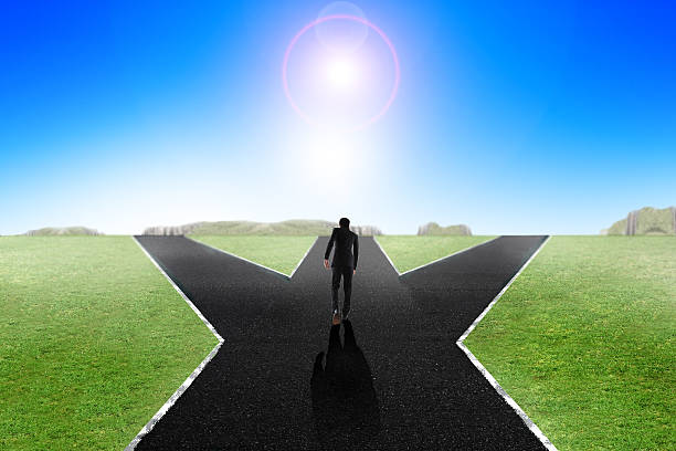 istock Business man walking down middle of the road, decision making 533567786
