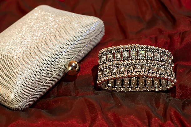 istock Bracelet with clear stones, shiny silver clutch bag. Stylish accessories 533572012