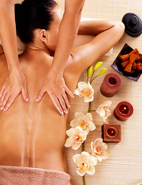istock Masseur doing massage on woman back in spa salon 533572836