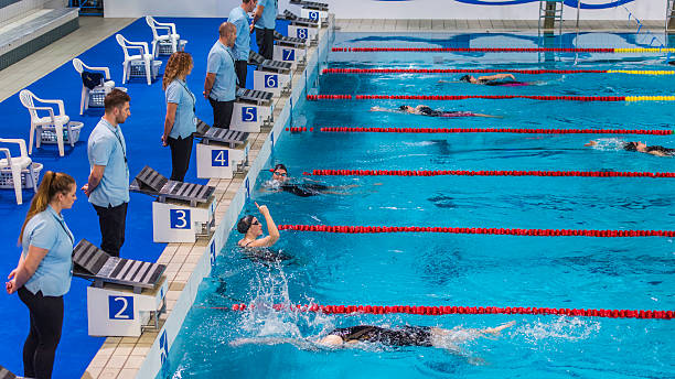 istock Swimmers in the pool, one with his arm raised 533573640