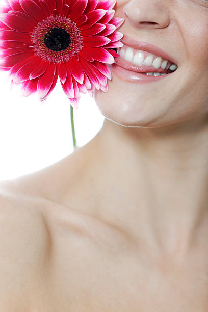 istock Woman biting at red flower 533573667