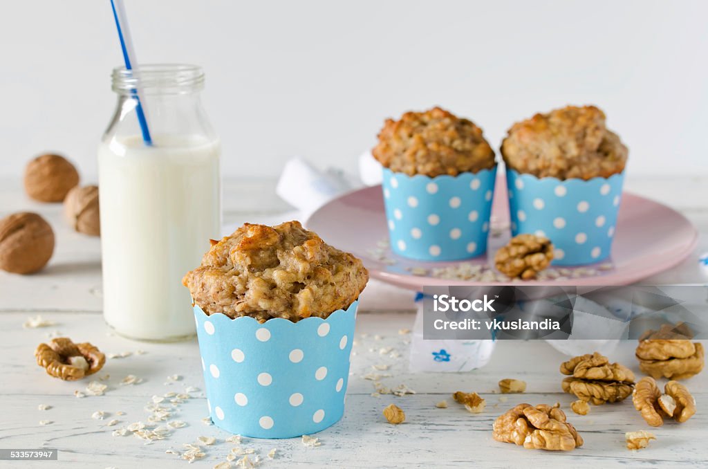 Banana muffins with oatmeal and nuts Banana muffins with oatmeal and walnuts on white table 2015 Stock Photo