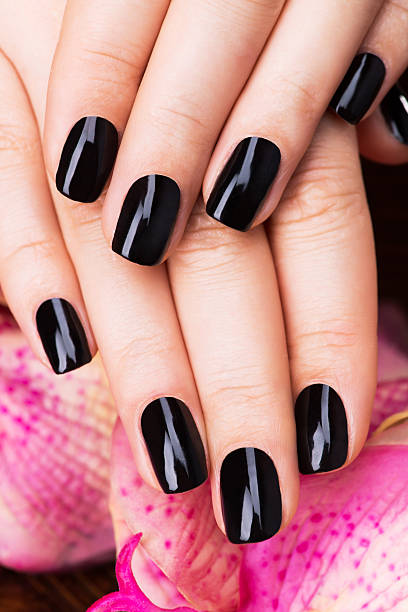 istock Beautiful women hands with black manicure 533575012