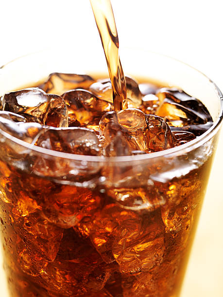 istock cola in glass cup with soft drink splash 533575115