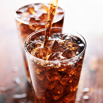 istock soft drink being poured into glass 533575209