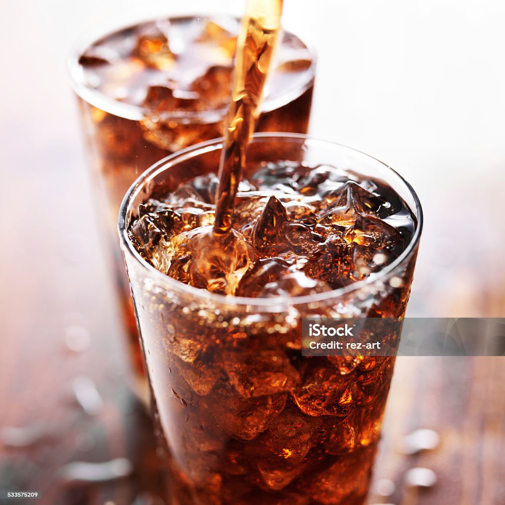 soft drink being poured into glass soft drink being poured into glass, shot with selective focus Soda Stock Photo