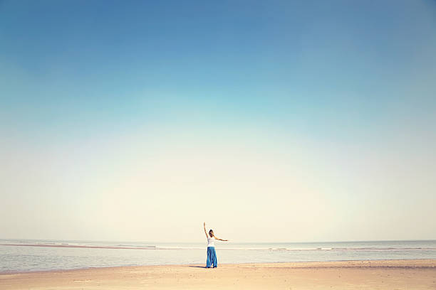 woman makes meditation exercises facing the sea