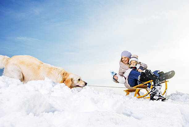 Cute little girl playing in the snow during cold winter day