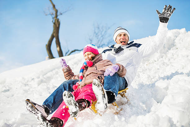 istock Father and daughter sledging in winter. 533576439