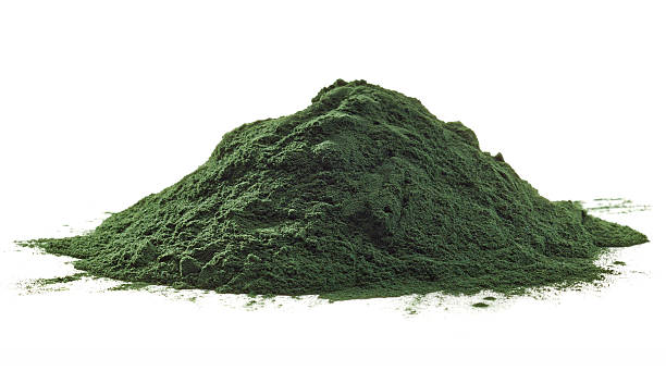 Spirulina algae powder Stack of spirulina algae powder isolated on white background chlorella stock pictures, royalty-free photos & images