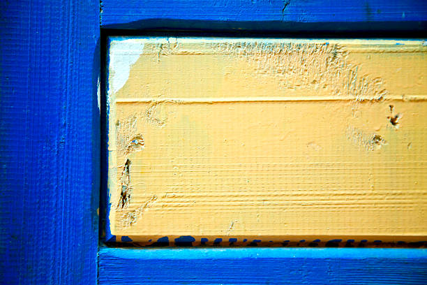 stripped paint in the blue wood door and rusty  nail