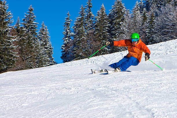 istock Male skier leaning on his edges going downhill at speed 533577223
