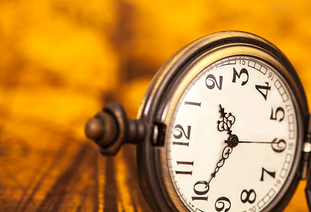 istock Pocket watch on old map background, light and tone 533577302