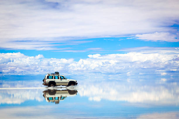 Sports Utility Vehicle driving in the Salar de Uyuni Old 4x4 in the Salar de Uyuni, Bolivia heaven photos stock pictures, royalty-free photos & images