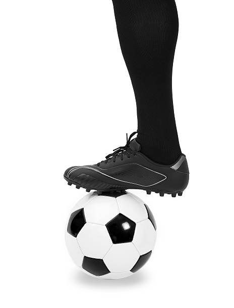istock Leg of soccer player with ball on white 533577937
