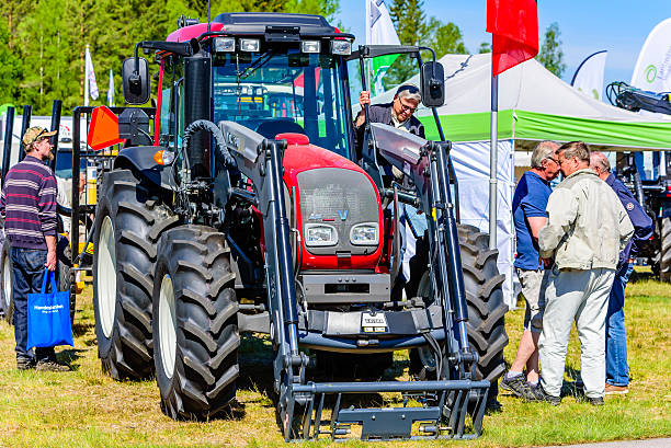Emmaboda, Sweden - May 13, 2016: Forest and tractor (Skog och traktor) fair. Visitors looking at a red Valtra A83 tractor.