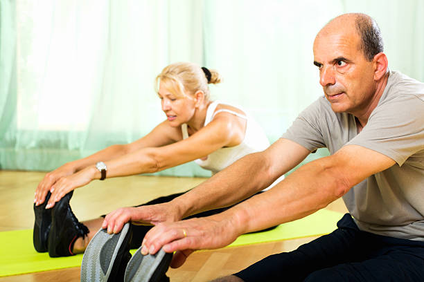 Pensioners doing exercises indoor