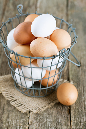 fresh farm eggs in iron basket