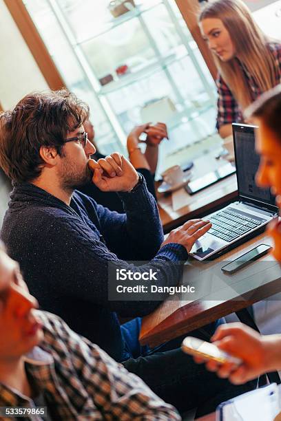 Young Man Using Laptop In Cafe Stock Photo - Download Image Now - 20-29 Years, 2015, Adult