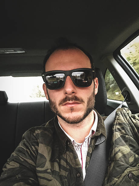 istock man on the car selfie 533580367