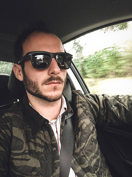 istock man on the car selfie 533580371