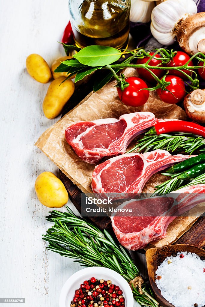 Raw lamb cutlets Raw lamb cutlets with vegetables, herbs and spices 2015 Stock Photo