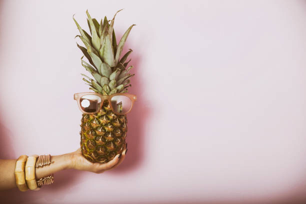 istock Woman holding pineapple with glasses. Summer concept image. 533581188