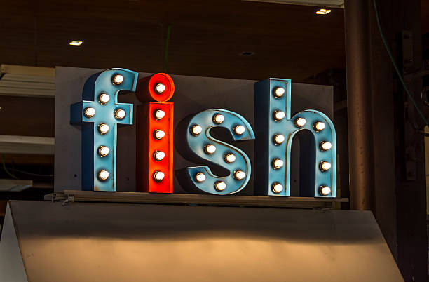 istock Brightly colored sign, advertising fish in a covered market 533582504