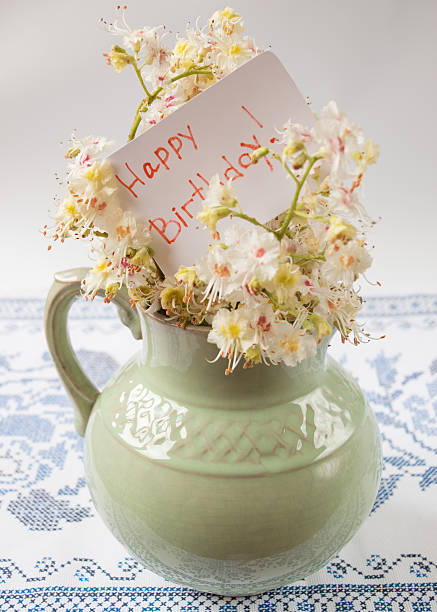 istock old pitcher with flowers of chestnut on a bautiful table 533583066