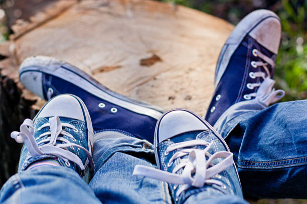 Woman and man sneakers shoes standing close feet
