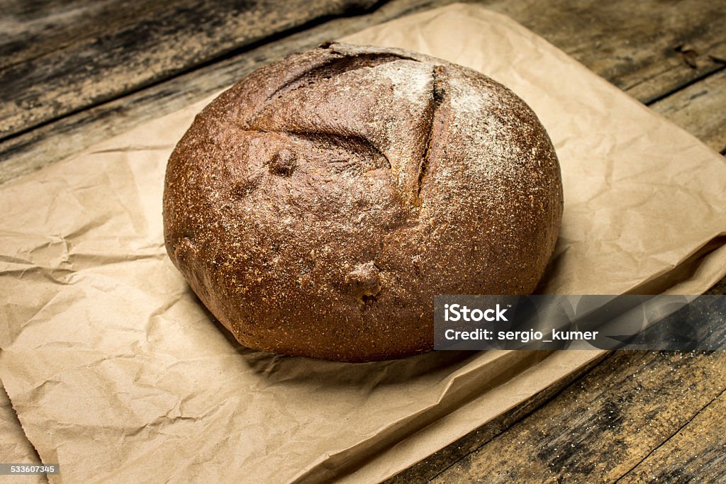 Loaf of rye breadon paper bag Loaf of rye breadon paper bag. Bakery background 2015 Stock Photo