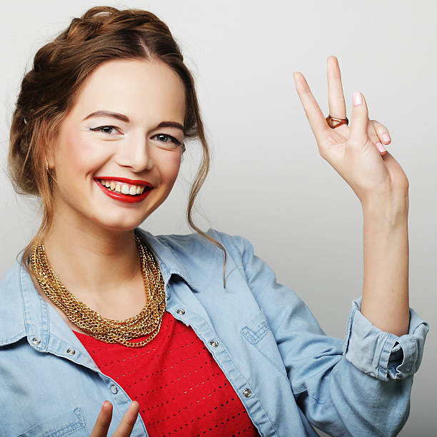 istock young woman showing thumbs up gesture 533608661