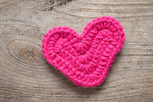 istock Crochet heart on old wooden table 533609491
