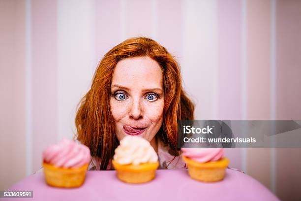 Young Woman Really Wants To Eat Cupcakes Stock Photo - Download Image Now - Desire, Eating, Cake