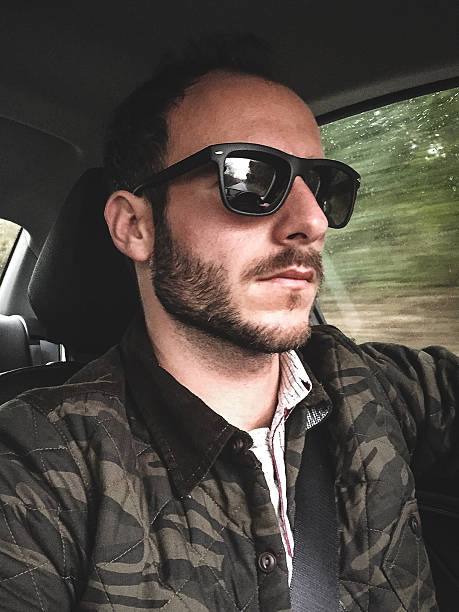 istock man on the car selfie 533609599