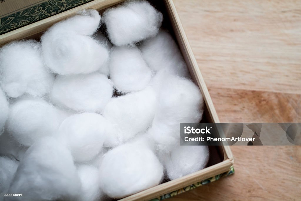 Cotton balls closeup photo of a cardboard box full of white cotton balls Cotton Ball Stock Photo