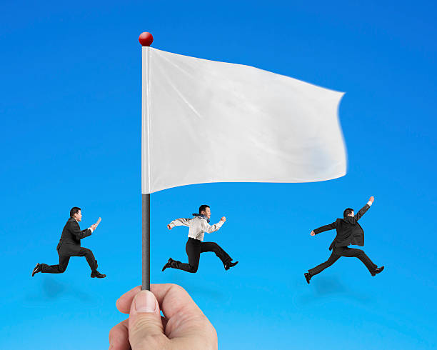 istock hand holding flag with businessmen running isolated on blue 533610097