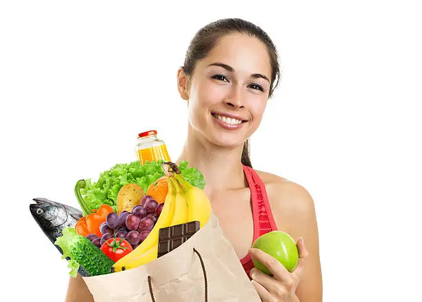 Photo of Young woman holding a grocery bag