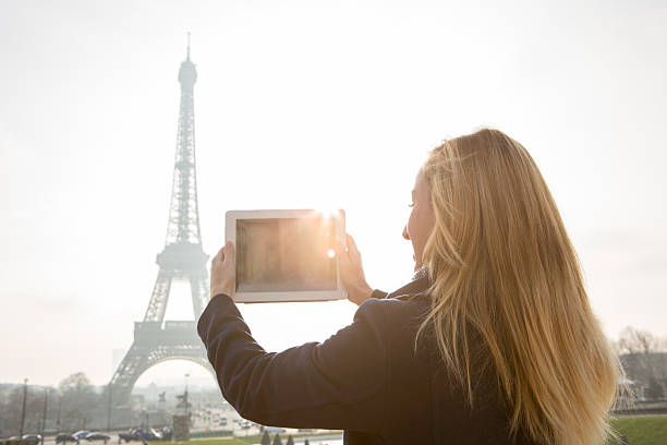 istock Woman takes picture with digital tablet-Eiffel tower,Paris-Winter sunlight 533610323