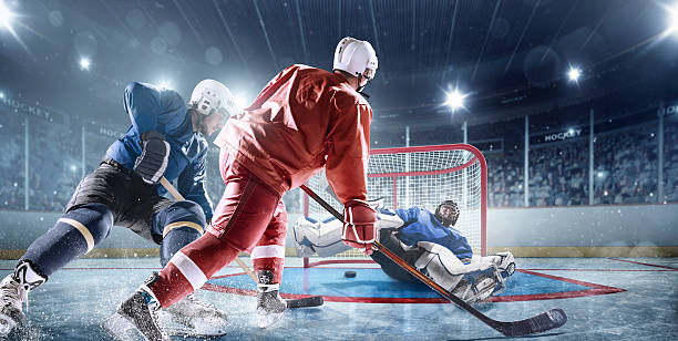 eishockey-spieler in aktion - ice hockey hockey puck playing shooting at goal stock-fotos und bilder