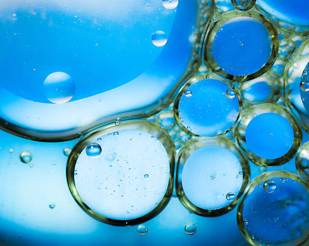 istock Oil drops on a water surface,blue background 533611983