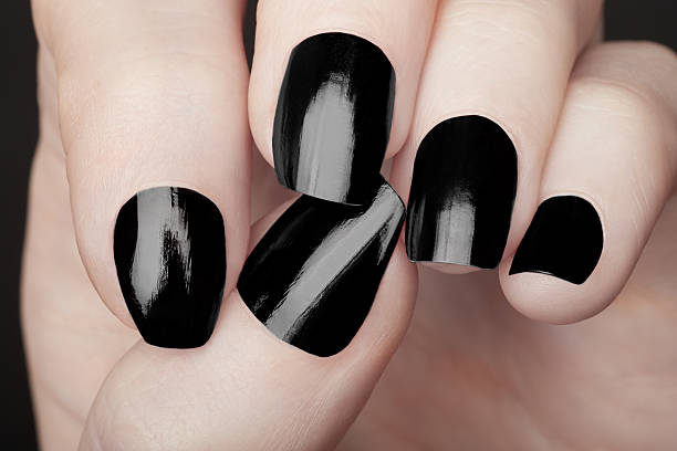 istock Manicure on female hands with black nail polish 533612759