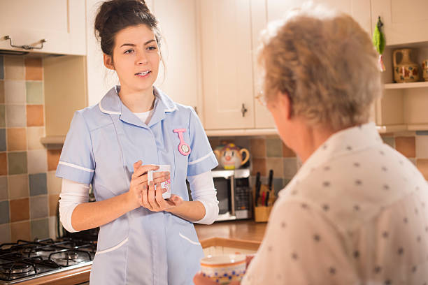 istock senior woman chats to care worker 533612807