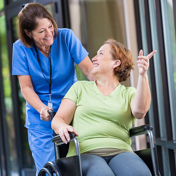 istock Patient talking with friendly nurse while being pushed in wheelchair 533613751