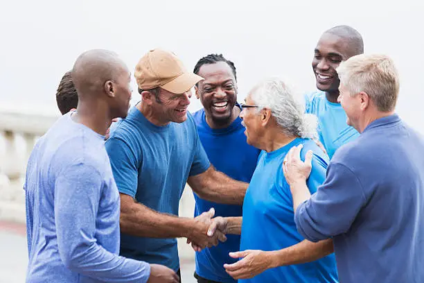 Photo of Multi-racial group of men,   shaking hands