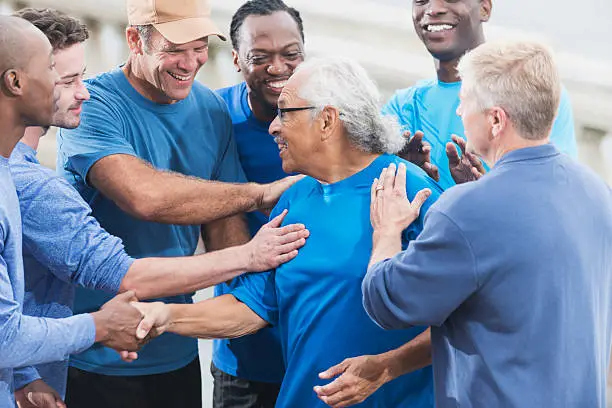 Photo of Senior Hispanic man talking with group of friends