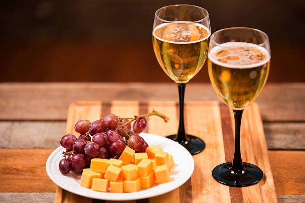 istock White wine tasting event. Cheese and red grapes. Wooden table. 533625867